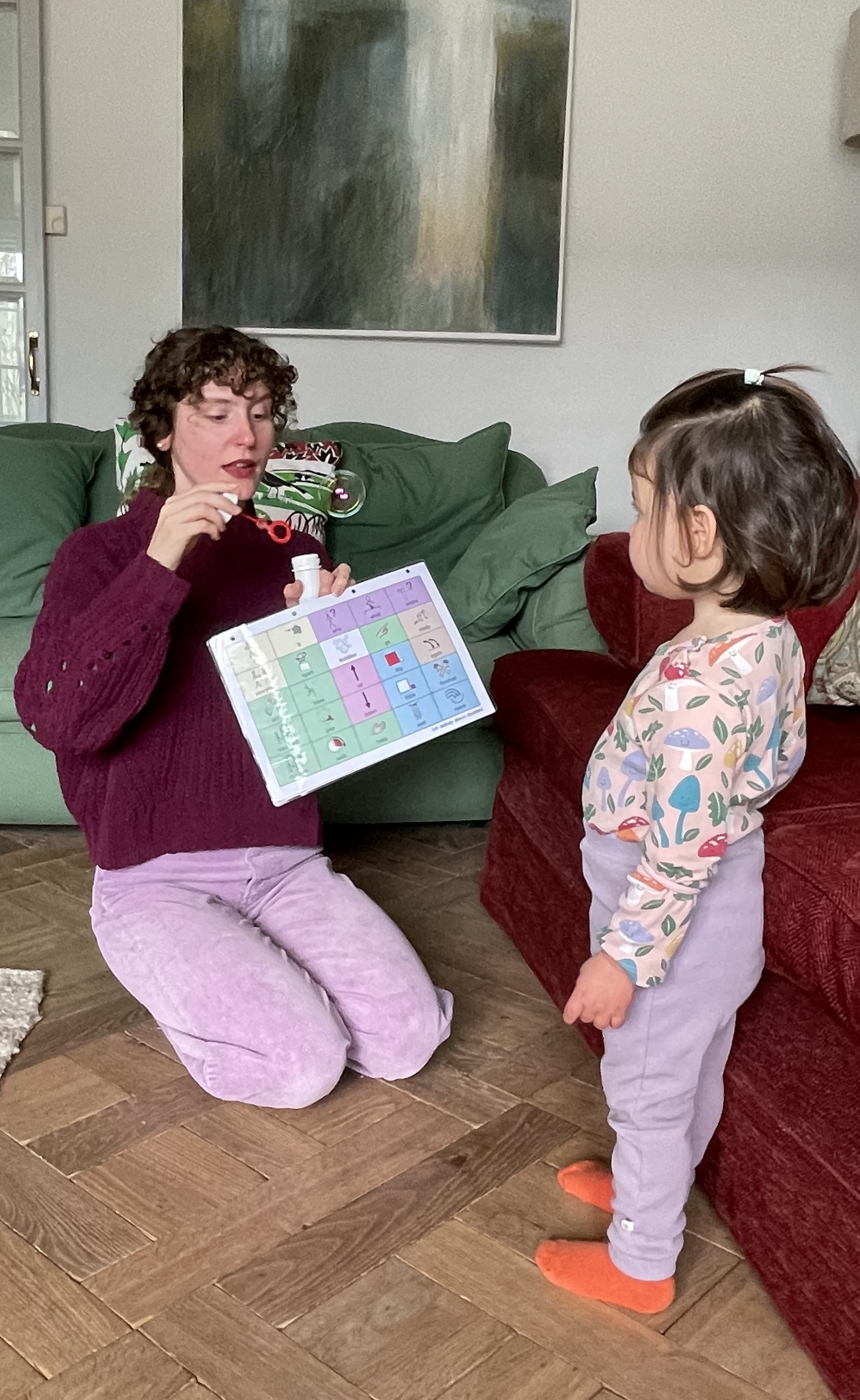 Rosalind blowing bubbles with a child